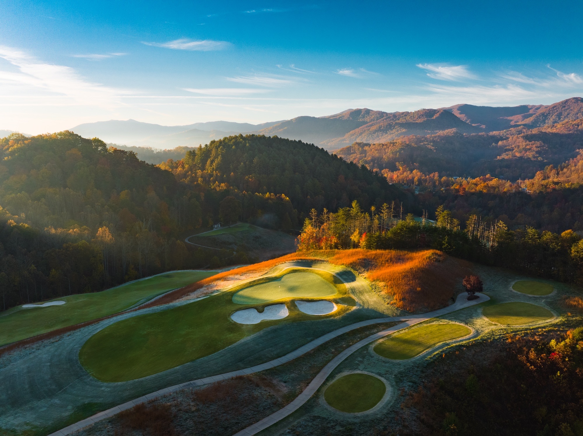 Sunrise illuminating a green at Sequoyah National in autumn
