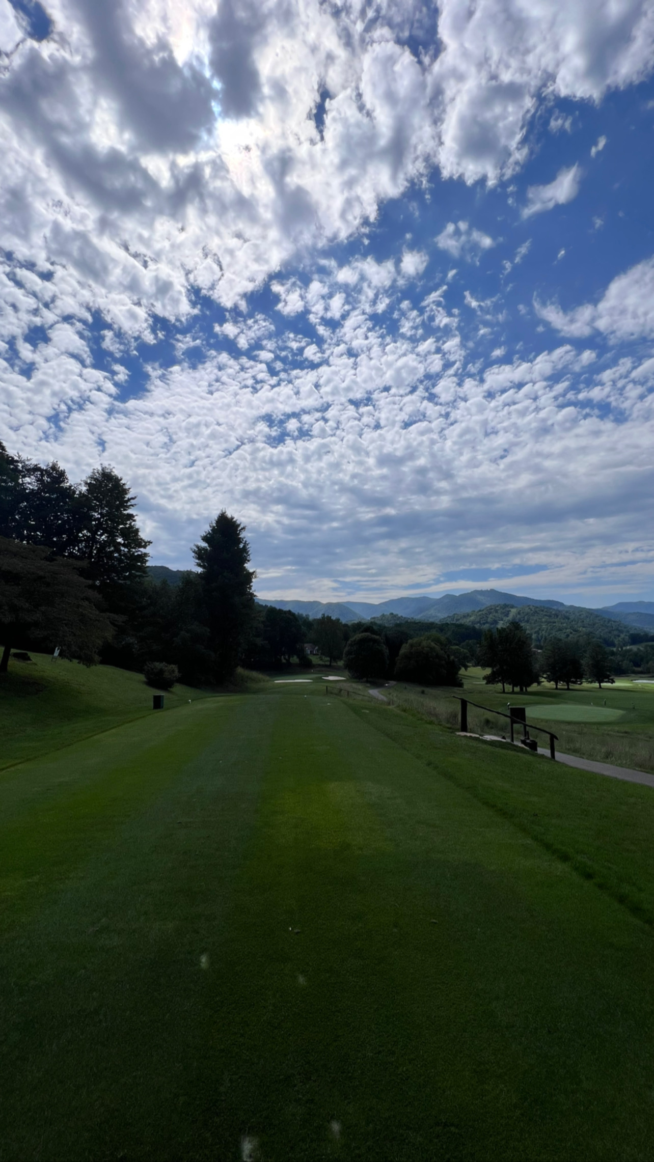 Cloud-filled sky above a mountain golf course during the 2023 weekend