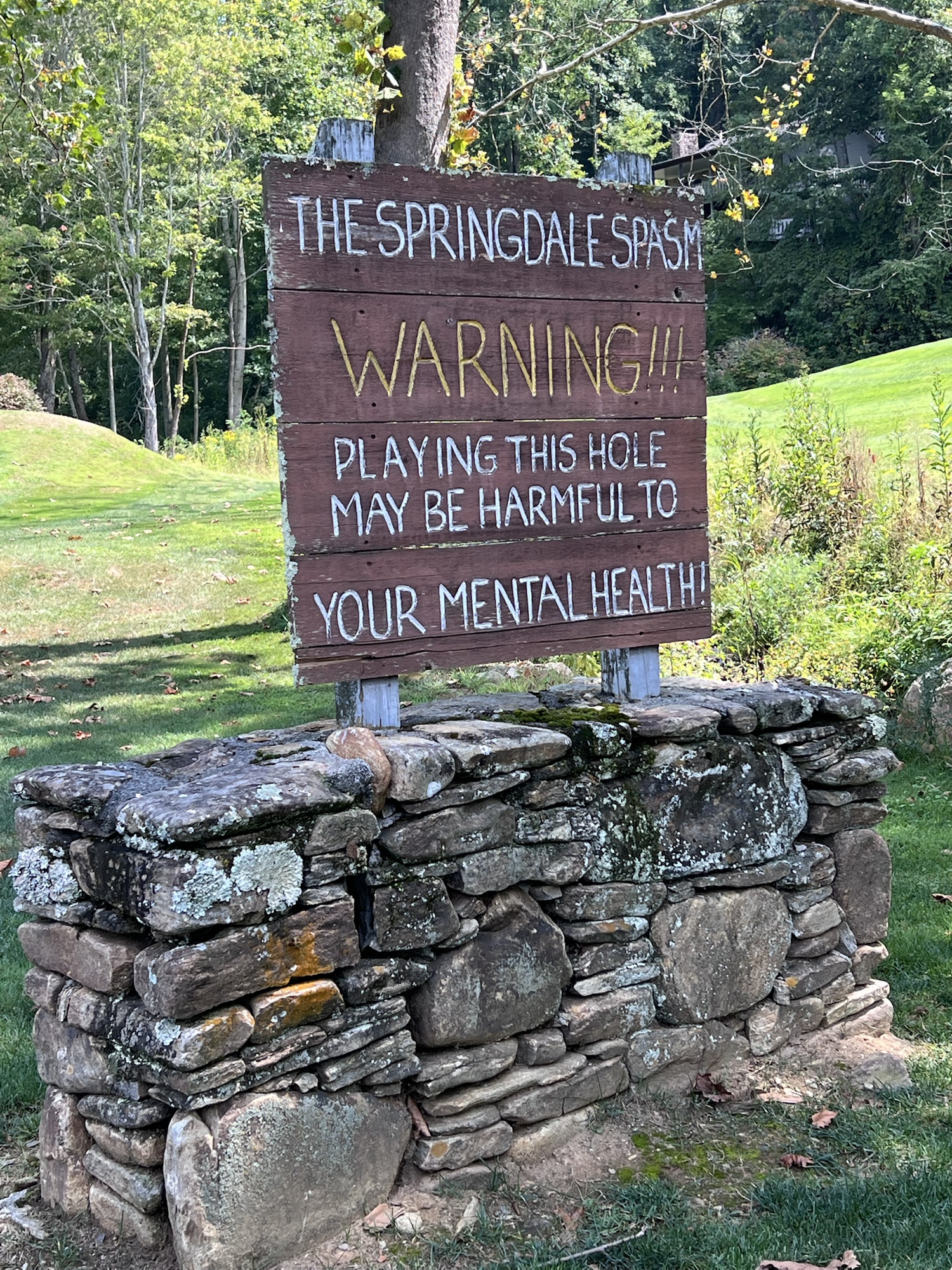 Full Springdale Spasm warning sign on its stone base