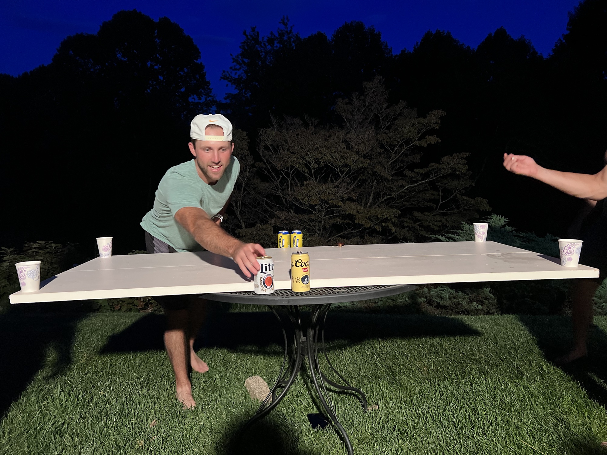 Participant playing beer die outdoors during the 2023 weekend