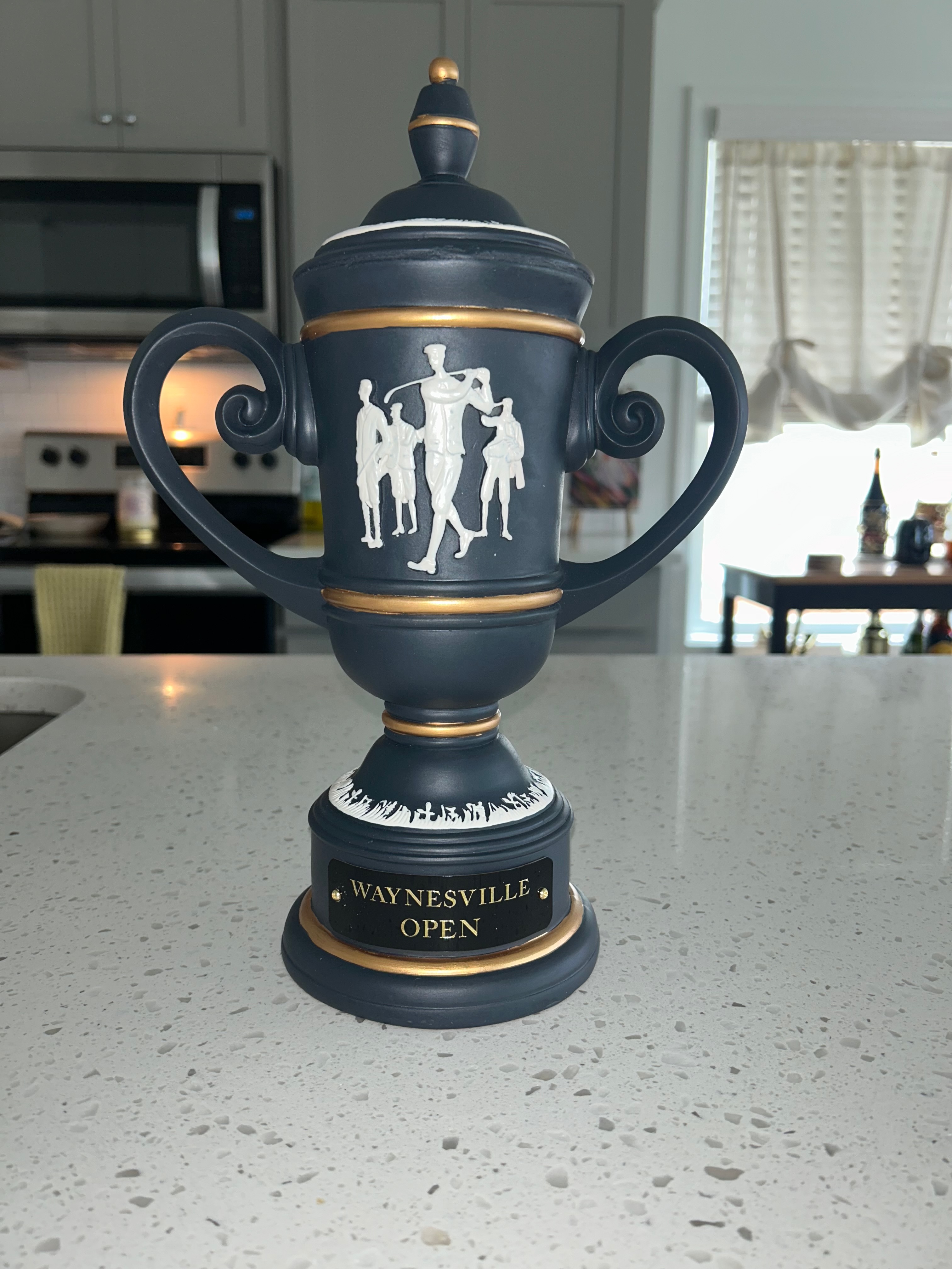 Front view of the black, white and gold Waynesville Open trophy